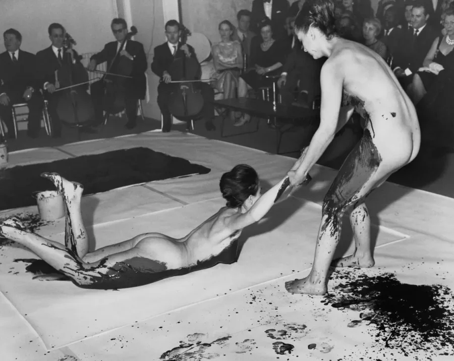 Archival photograph of a body painting performance before an audience