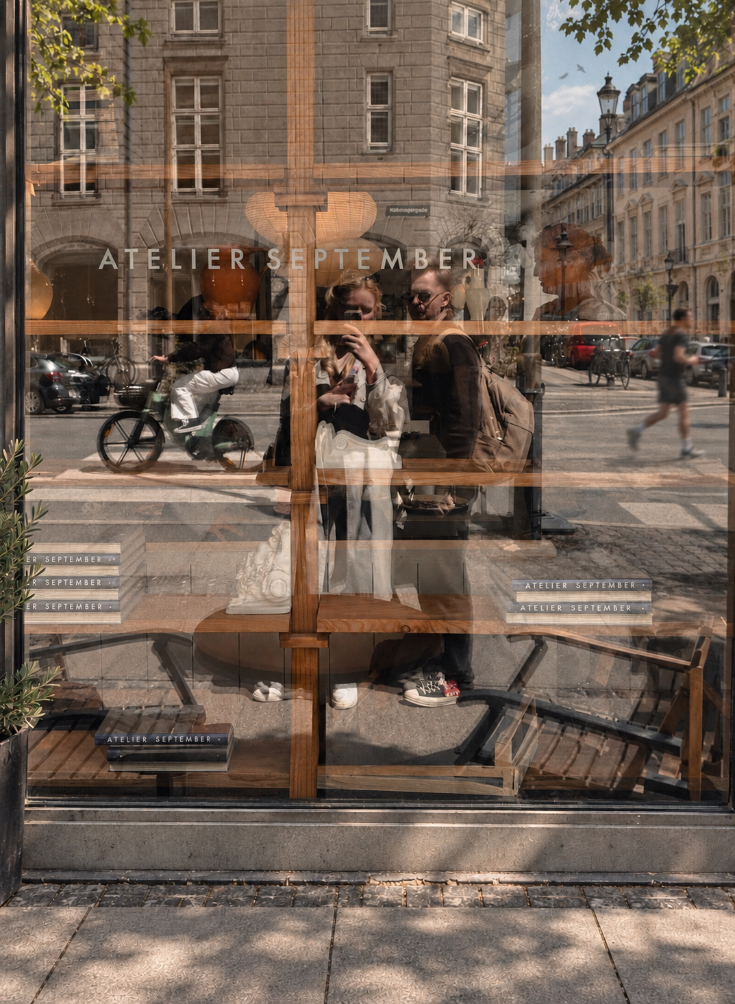 Two people reflected in the window of Atelier September