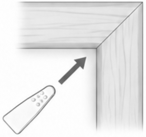 A wedge being pushed into a frame corner from behind